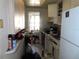 Small kitchen with appliances and cabinets; cluttered at 5920 18Th N St # 21, St Petersburg, FL 33714