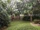 Landscaped backyard with lush greenery and mature trees at 6769 Breezy Palm Dr, Riverview, FL 33578