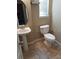 Small bathroom with pedestal sink and tiled floor at 6769 Breezy Palm Dr, Riverview, FL 33578