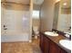 Clean bathroom with double vanity, soaking tub, and tile flooring at 6769 Breezy Palm Dr, Riverview, FL 33578