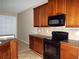 Kitchen with dark wood cabinets and granite countertops at 6769 Breezy Palm Dr, Riverview, FL 33578