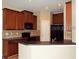 Kitchen with dark wood cabinets, granite counters, and black appliances at 6769 Breezy Palm Dr, Riverview, FL 33578