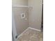 Laundry area with tile flooring and overhead shelving at 6769 Breezy Palm Dr, Riverview, FL 33578