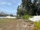 Large backyard with garden and white vinyl fence at 7336 Orchard Dr, Wesley Chapel, FL 33545