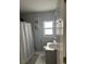 Second bathroom with shower/tub combo and gray geometric shower curtain at 7336 Orchard Dr, Wesley Chapel, FL 33545