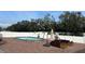 Above ground oval pool with brick patio and seating at 7336 Orchard Dr, Wesley Chapel, FL 33545