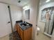 Clean bathroom with dark countertop, light wood cabinets, and shower/tub combo at 7533 Pitch Pine Cir # 18, Tampa, FL 33617