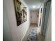 Bright hallway showcasing artwork and wood-look floors at 7533 Pitch Pine Cir # 18, Tampa, FL 33617