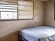 Simple bedroom with a double bed and window at 7607 Lavender Ln, Tampa, FL 33619