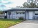 Gray house with carport and small front yard at 7607 Lavender Ln, Tampa, FL 33619