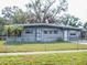 Ranch-style home with a fenced yard and carport at 7607 Lavender Ln, Tampa, FL 33619