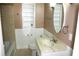 Bathroom with a tub, vanity, and neutral tile at 8006 N Rome Ave, Tampa, FL 33604