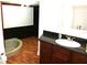 Bathroom with soaking tub, granite vanity, and tile floors at 8006 N Rome Ave, Tampa, FL 33604