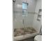 Stylish bathroom with a glass-enclosed shower and pebble floor at 8006 N Rome Ave, Tampa, FL 33604