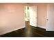 Spacious bedroom with hardwood floors and access to staircase at 8006 N Rome Ave, Tampa, FL 33604