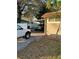 Carport with two parked trucks and side yard at 8006 N Rome Ave, Tampa, FL 33604