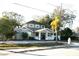 Two-story house with gray brick, palm tree, and a paved driveway at 8006 N Rome Ave, Tampa, FL 33604