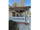 Covered front porch with white columns, copper gutters, and brick pavers at 8006 N Rome Ave, Tampa, FL 33604