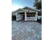 Front porch with white balustrade, brick pavers, and double doors at 8006 N Rome Ave, Tampa, FL 33604