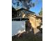 House side view, showing white fence and carport at 8006 N Rome Ave, Tampa, FL 33604