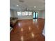 Bright living room featuring hardwood floors, large windows, and French doors at 8006 N Rome Ave, Tampa, FL 33604