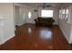 Living room with hardwood floors, and view to the hallway and staircase at 8006 N Rome Ave, Tampa, FL 33604