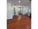 Hardwood floor living room with access to the staircase and bathroom at 8006 N Rome Ave, Tampa, FL 33604