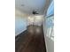 Spacious loft area with hardwood floors and a charming chandelier at 8006 N Rome Ave, Tampa, FL 33604