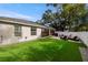 Spacious backyard with artificial turf, patio, and screened enclosure at 808 W Hollywood St, Tampa, FL 33604