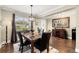 Dining room with granite top table, dark wood floors, and large art at 808 W Hollywood St, Tampa, FL 33604