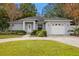 Gray house with a two-car garage and landscaped lawn at 808 W Hollywood St, Tampa, FL 33604