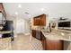 Kitchen with granite countertops, dark wood cabinets, and stainless steel appliances at 808 W Hollywood St, Tampa, FL 33604