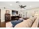 Living room with sectional sofa, large TV, and hardwood floors at 808 W Hollywood St, Tampa, FL 33604