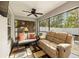 Relaxing screened porch with seating and ceiling fan at 808 W Hollywood St, Tampa, FL 33604