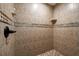 Walk-in shower with tile surround and built-in shelving at 808 W Hollywood St, Tampa, FL 33604