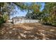 Side yard with gravel and mature trees at 808 W Hollywood St, Tampa, FL 33604