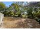 Large side yard with mature trees and partial fence at 808 W Hollywood St, Tampa, FL 33604