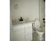 Bathroom with white vanity, black fixtures, and marble accents at 8206 N Marks St, Tampa, FL 33604