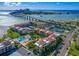 Aerial view of a waterfront community with tennis courts, pool, and lush landscaping at 845 S Gulfview Blvd # 208, Clearwater Beach, FL 33767