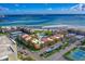 Aerial view of waterfront community with pool and tennis courts at 845 S Gulfview Blvd # 208, Clearwater Beach, FL 33767