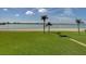 Beachfront property with grassy area and palm trees at 845 S Gulfview Blvd # 208, Clearwater Beach, FL 33767