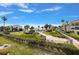 Resort-style pool and patio area with lush landscaping and water views at 845 S Gulfview Blvd # 208, Clearwater Beach, FL 33767