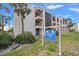 Condo building exterior showcasing landscaping and signage at 845 S Gulfview Blvd # 208, Clearwater Beach, FL 33767