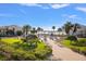 Community pool with lounge chairs and water view at 845 S Gulfview Blvd # 208, Clearwater Beach, FL 33767