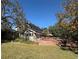 House back view with large deck and yard at 9850 Hilltop Dr, New Port Richey, FL 34654