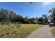 House with a long driveway and white fence at 9850 Hilltop Dr, New Port Richey, FL 34654