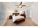 Main bedroom with king bed, ceiling fan, and en-suite bathroom at 10010 Bucklin St, Tampa, FL 33625