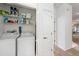 Convenient laundry room with washer, dryer, and storage shelves at 10010 Bucklin St, Tampa, FL 33625