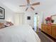 Spacious bedroom with king-size bed, dresser, and ceiling fan at 1012 Pearce Dr # 211, Clearwater, FL 33764