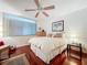 Serene bedroom with king-size bed, ceiling fan, and wood floors at 1012 Pearce Dr # 211, Clearwater, FL 33764